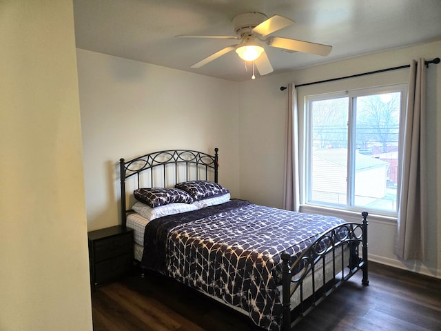 bedroom with ceiling fan and dark hardwood / wood-style floors