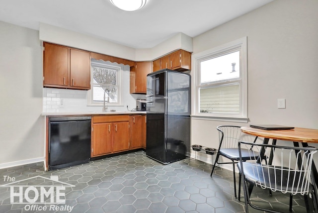 kitchen featuring decorative backsplash, sink, and black appliances