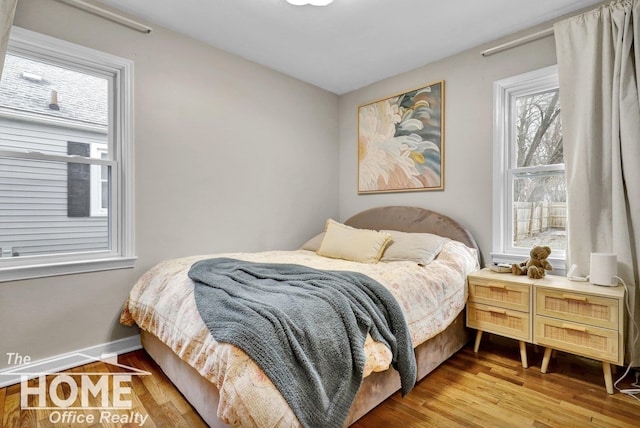 bedroom with hardwood / wood-style floors