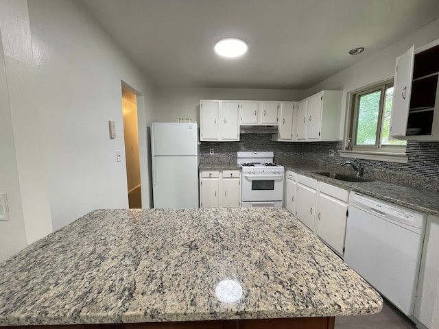 kitchen with sink, backsplash, dark stone counters, white appliances, and white cabinets