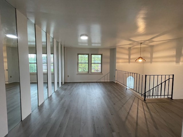 unfurnished room with dark hardwood / wood-style flooring