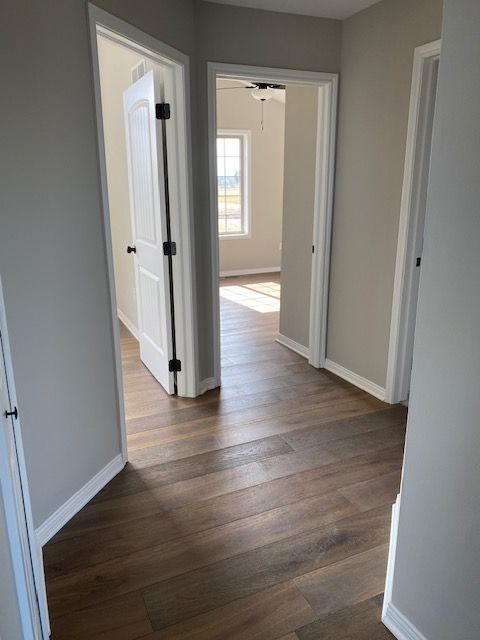 hallway with dark hardwood / wood-style floors