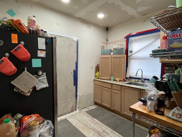 kitchen featuring stainless steel fridge and sink