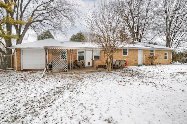 snow covered house with a garage