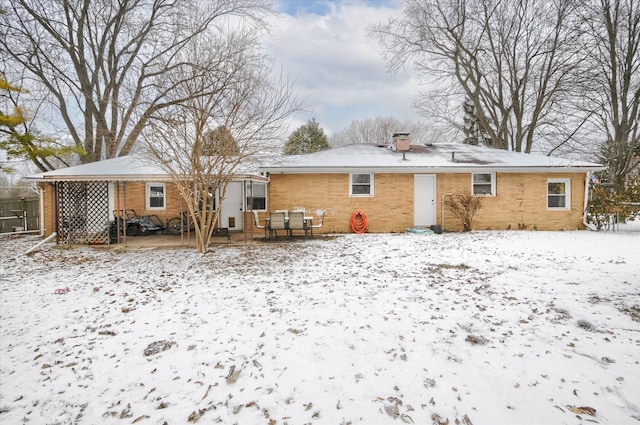 view of snow covered rear of property