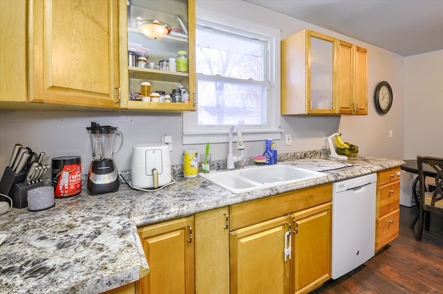 kitchen featuring dishwasher, sink, dark wood-type flooring, and light stone counters