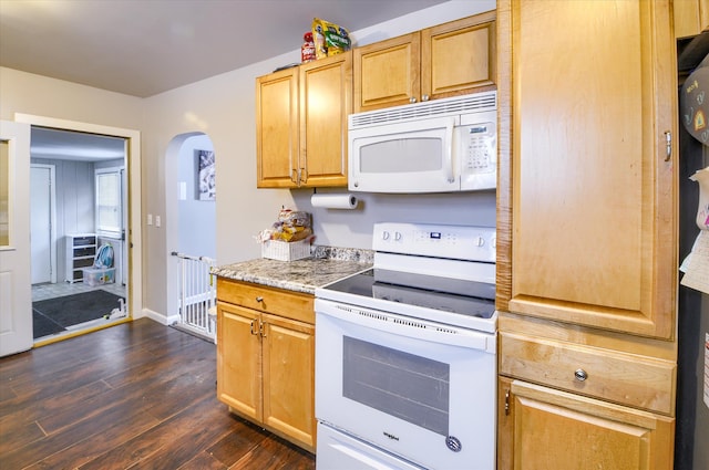 kitchen with white appliances and dark hardwood / wood-style floors