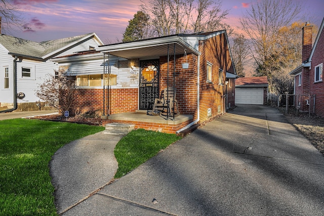 view of front of property with an outbuilding, a garage, and covered porch