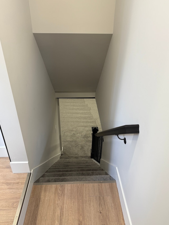 stairs featuring baseboards and wood finished floors