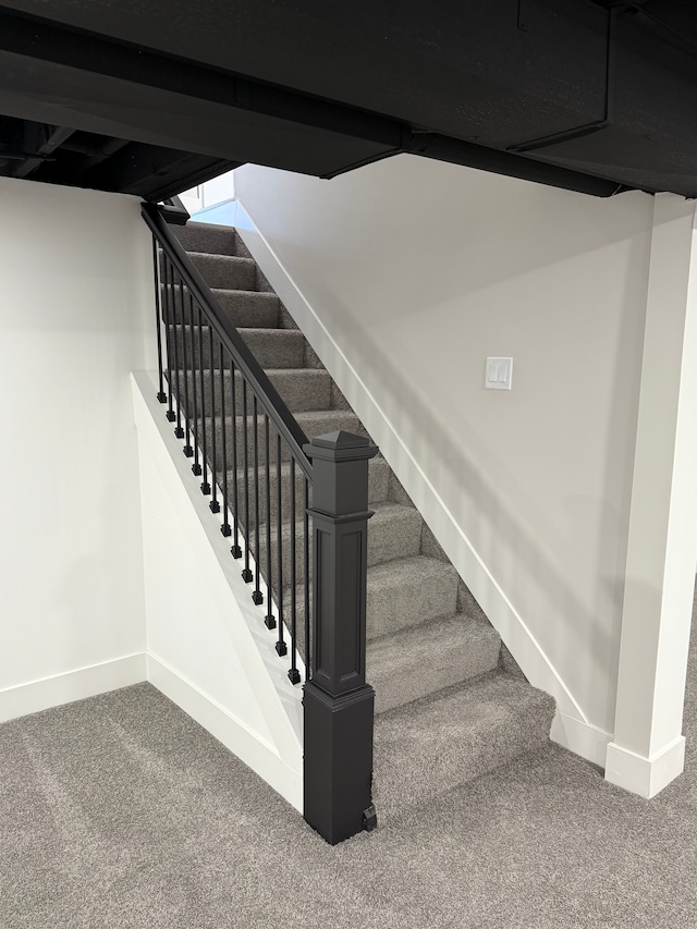 stairway with baseboards and carpet flooring