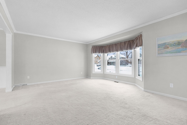 carpeted spare room featuring a textured ceiling and ornamental molding