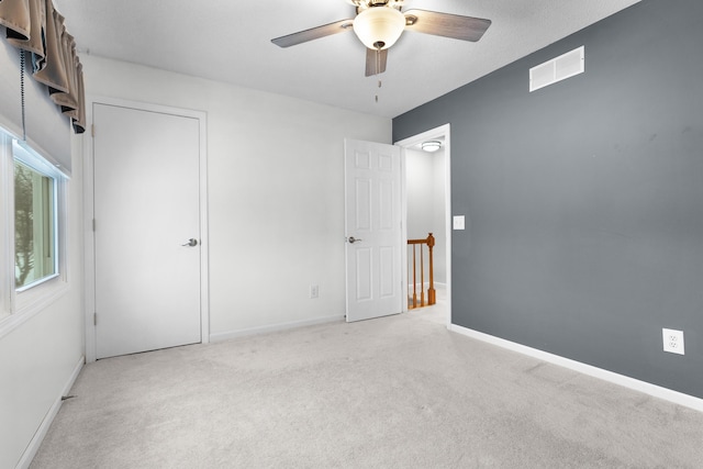 carpeted empty room with ceiling fan