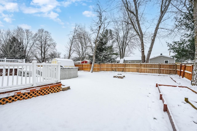 yard covered in snow featuring a wooden deck