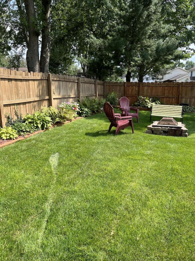 view of yard with an outdoor fire pit