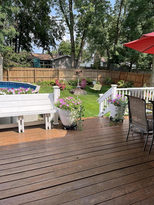 wooden terrace with a lawn