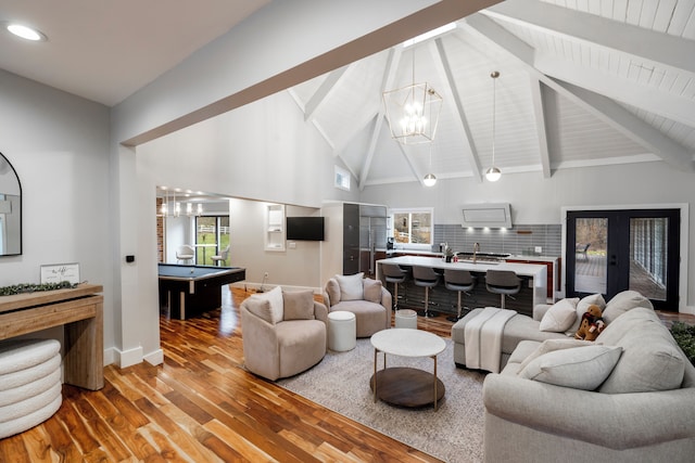 living room featuring an inviting chandelier, pool table, high vaulted ceiling, beamed ceiling, and hardwood / wood-style floors