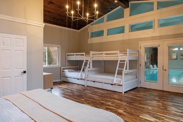 unfurnished bedroom with french doors, a chandelier, high vaulted ceiling, dark hardwood / wood-style floors, and beamed ceiling