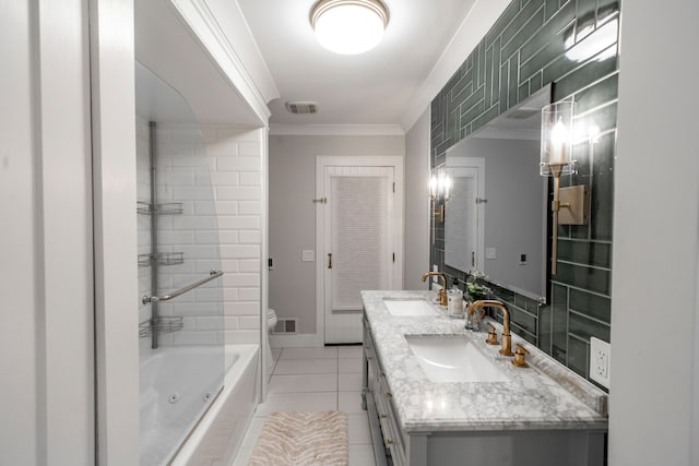 full bathroom with toilet, crown molding, vanity, tiled shower / bath combo, and tile patterned flooring