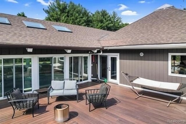 wooden terrace featuring an outdoor hangout area and french doors