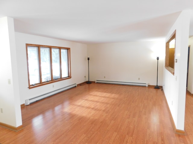 spare room with light hardwood / wood-style flooring and a baseboard heating unit