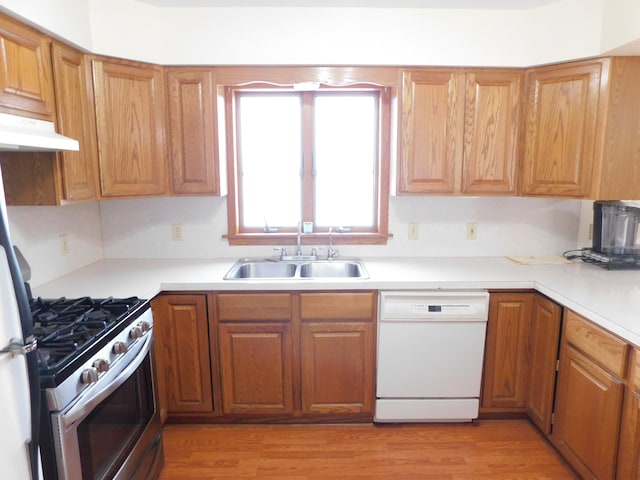 kitchen with dishwasher, light wood-type flooring, sink, and stainless steel range with gas stovetop