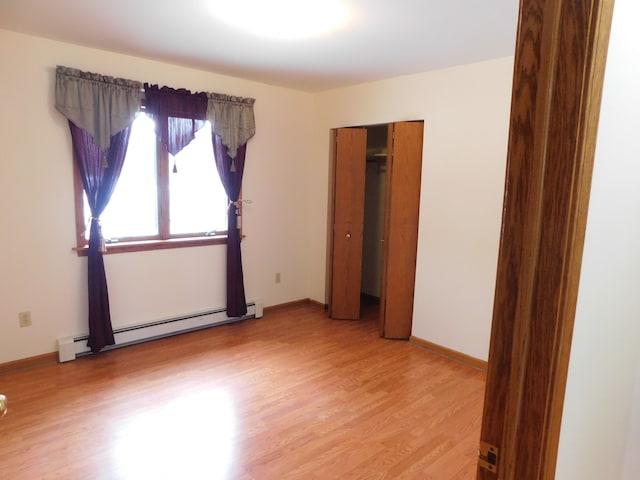 spare room featuring hardwood / wood-style floors and baseboard heating