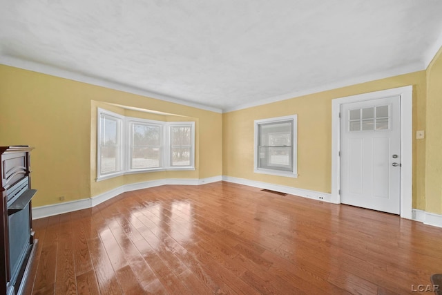 unfurnished living room featuring hardwood / wood-style floors