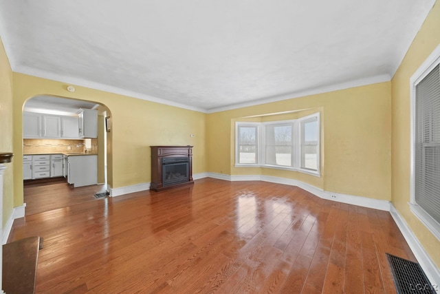 unfurnished living room featuring light hardwood / wood-style floors and sink