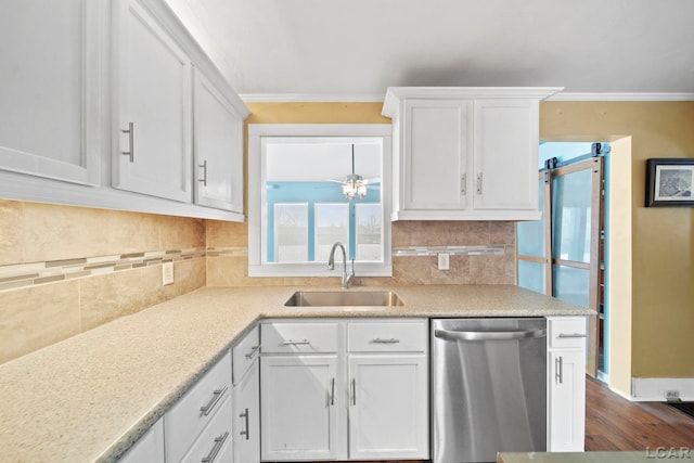 kitchen featuring white cabinets, tasteful backsplash, crown molding, sink, and dishwasher