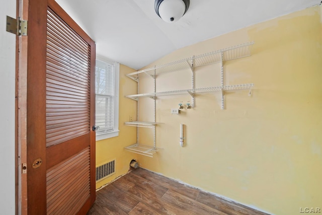 clothes washing area with wood-type flooring and hookup for a washing machine