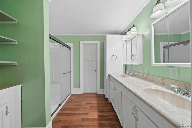 bathroom featuring wood-type flooring, a textured ceiling, and ornamental molding