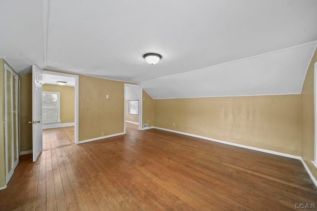 bonus room featuring wood-type flooring and vaulted ceiling