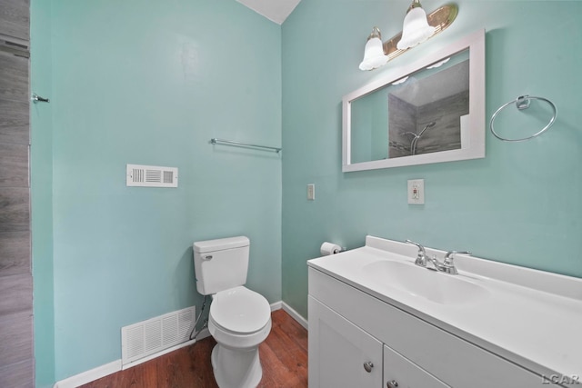 bathroom with wood-type flooring, vanity, and toilet