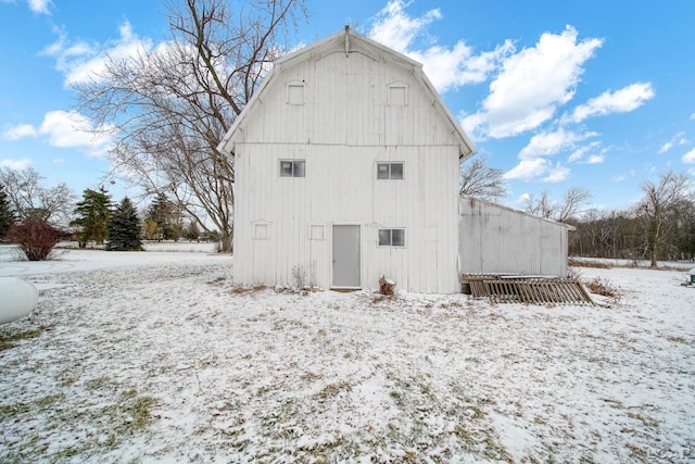 view of snow covered rear of property