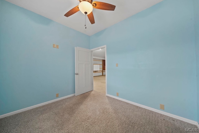 carpeted spare room featuring ceiling fan