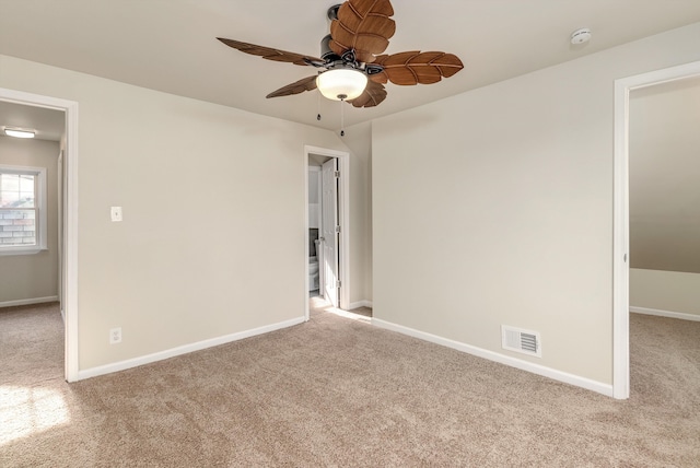 carpeted spare room with ceiling fan