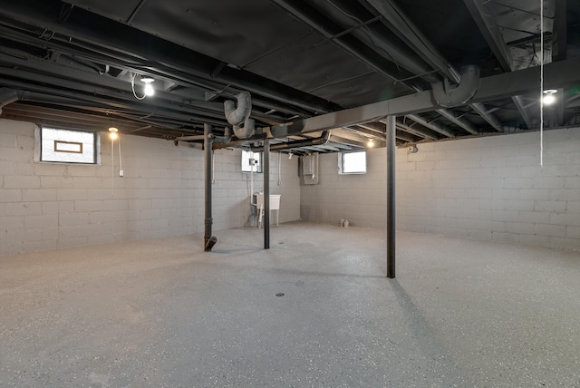 basement featuring electric panel and sink