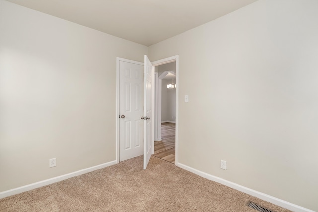 spare room with light colored carpet