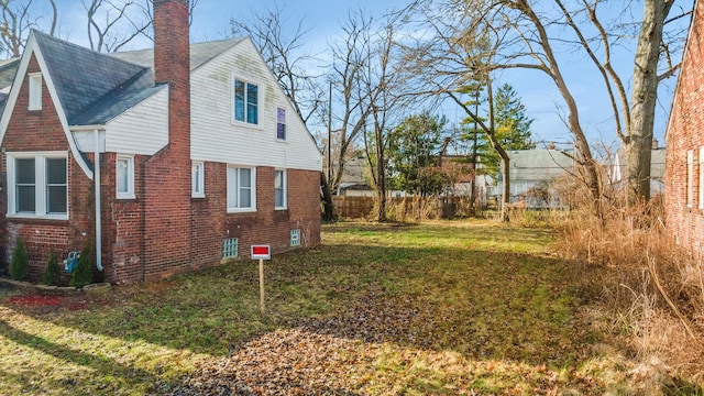 view of property exterior with a lawn