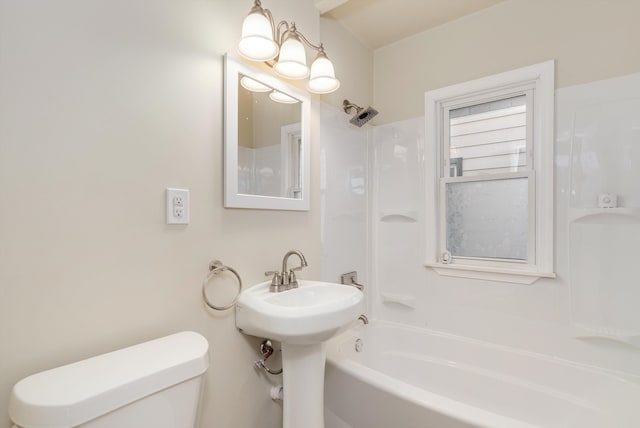 bathroom with shower / bathing tub combination and toilet