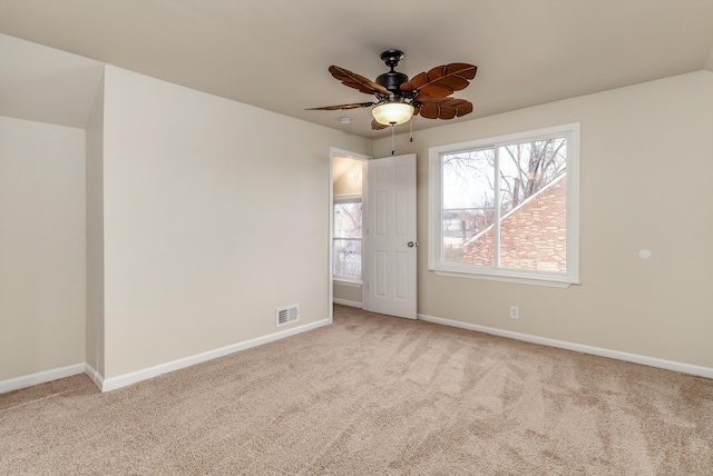 unfurnished room with light carpet, plenty of natural light, and ceiling fan