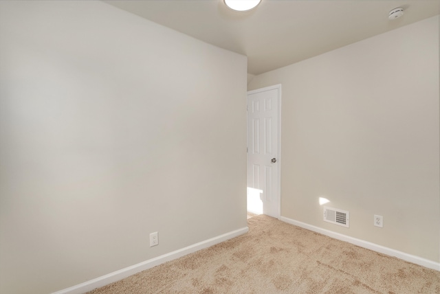 empty room featuring light colored carpet