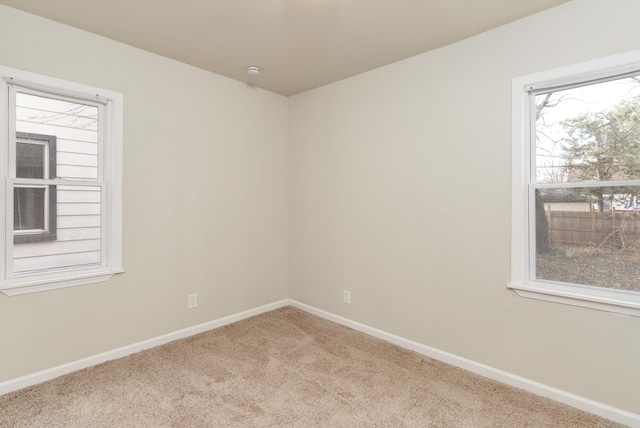 spare room with plenty of natural light and light carpet