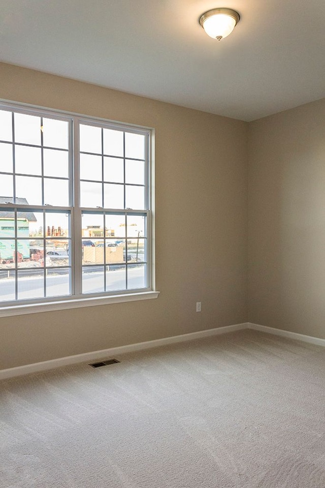 unfurnished room with carpet flooring