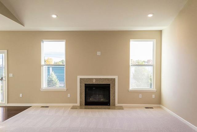 unfurnished living room with light colored carpet