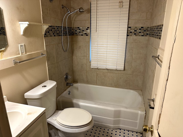 full bathroom featuring tile patterned floors, vanity, tiled shower / bath combo, and toilet