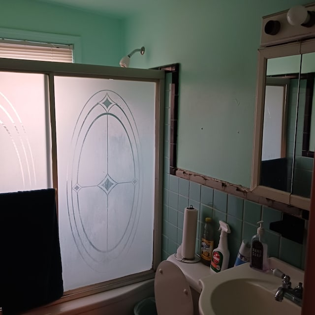 bathroom featuring tile walls and sink