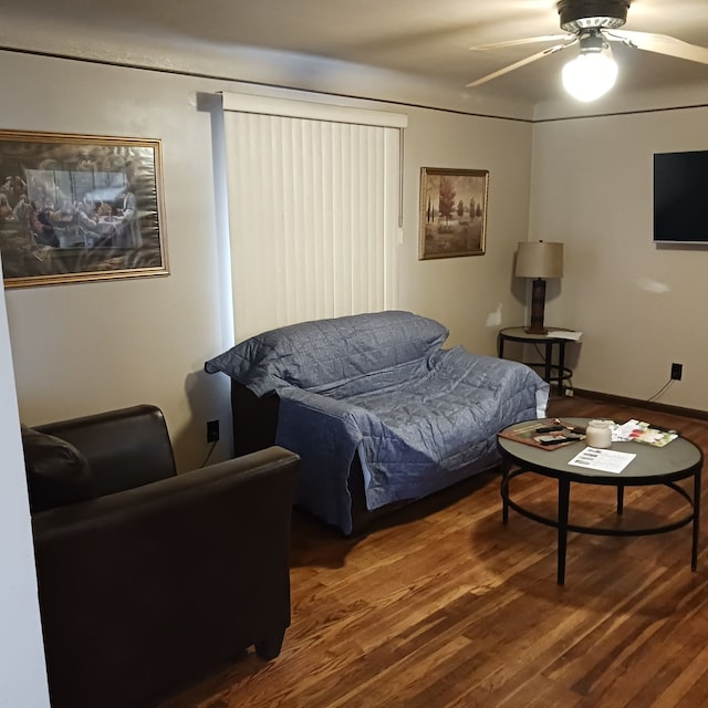 living room featuring ceiling fan and hardwood / wood-style floors