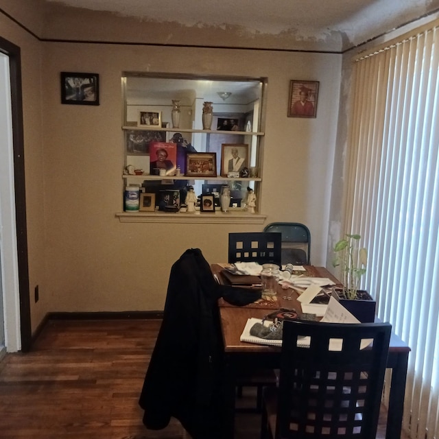 dining space with plenty of natural light and dark wood-type flooring