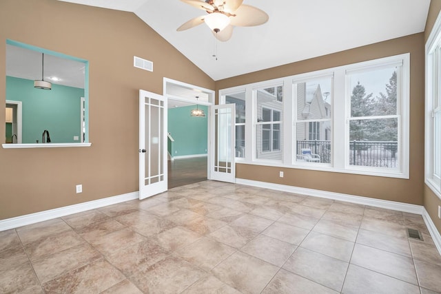 spare room featuring ceiling fan, french doors, and vaulted ceiling